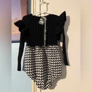 One Child. NWT Body suit for toddler girls in black and white in size 3. NWT